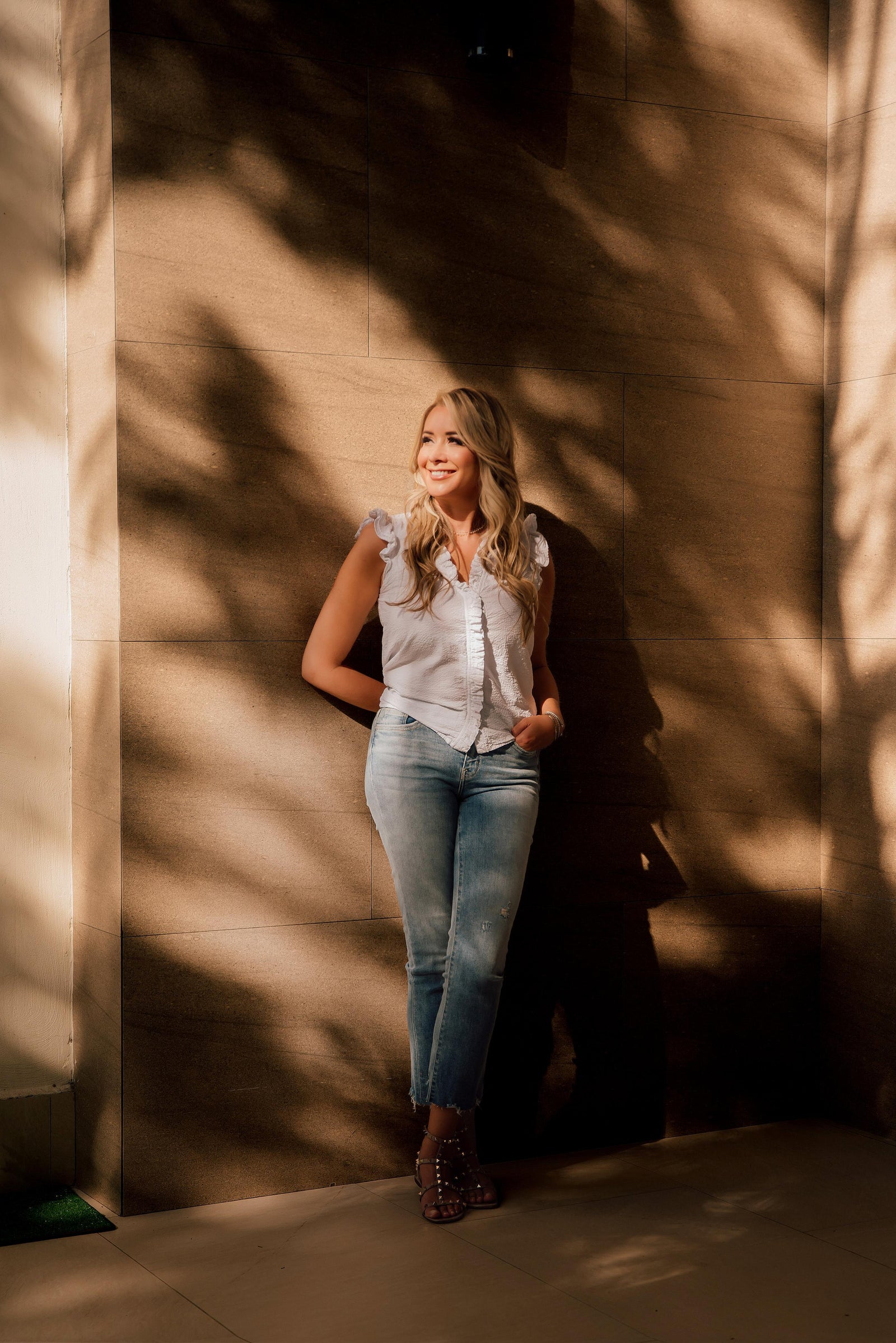 A woman is standing in blue pent and white shirt